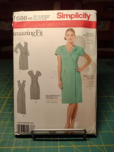 a sewing pattern for a women's dress on a cutting board