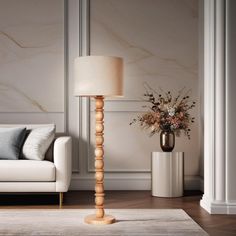 a living room with a couch, table lamp and vase on top of the floor