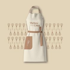 a white apron with a brown ribbon on it and an image of utensils in the background