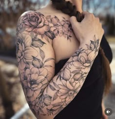 a woman with tattoos on her arms and shoulder