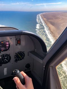 the cockpit of an airplane flying over water