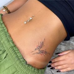 a woman's stomach with a small tattoo on her back and the bottom part of her body