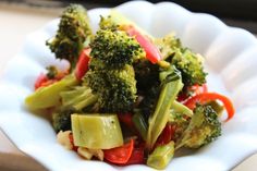 a white plate topped with broccoli and red peppers