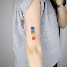 a woman with a rainbow tattoo on her arm