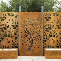 an outdoor privacy wall with trees and leaves painted on the sides, in front of a white tiled floor