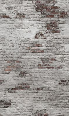 an old brick wall that has been painted white