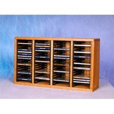 a large wooden cabinet with many compartments for cd's