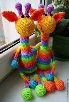 two crocheted giraffes sitting next to each other