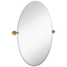 an oval mirror with brass fittings