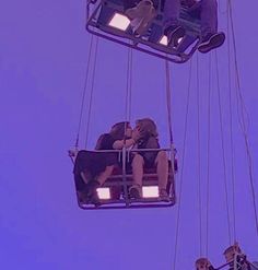 two people are sitting on a ferris wheel