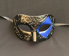 This men's Venetian masquerade mask has raised detail and is hand painted blue and black. Mask is lightweight, durable and has a comfortable fit. Comes with silk black ribbon ties attached. Mask is great for any Masquerade mask party! Masquerade Mask Party, Mask Venetian, Venetian Masquerade Masks, Venetian Masquerade, Masquerade Masks, Costume Masks, Masks Masquerade, Costume Mask, Black Mask