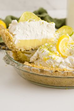 there is a pie with lemons and whipped cream in the pie dish on the table