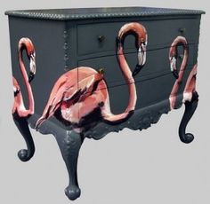 an old chest with pink flamingos painted on it's sides and legs,