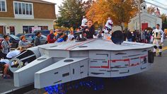 a group of people riding on the back of a white vehicle