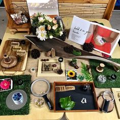 a table with various items on it including cards, flowers and other things to make an origami boat