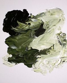 an abstract painting with black and green colors on white paper in the middle of it