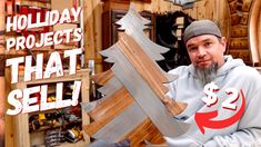 a man holding up a large wooden christmas tree with the words holiday projects that sell on it