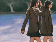 two young women dressed in business attire walking through the snow