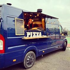 a blue van is parked in a parking lot