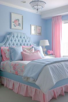 a bedroom with blue walls, pink and white bedspreads, and a chandelier