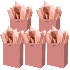 six pink bags with tissue paper in them