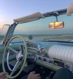 the interior of an old car with dashboard, steering wheel and dash light on it