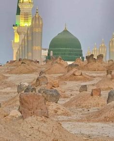 a large green dome in the middle of a desert with rocks and sand around it