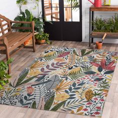 an indoor area rug with plants and benches