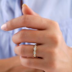 a woman's hand with a diamond ring on it