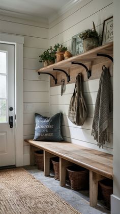 The farmhouse-style entryway adds vintage charm to any home. Choose distressed wood, shiplap walls, and classic details like enamel buckets or woven baskets. This design is both useful and makes the entryway feel welcoming. Small Hallway Mudroom Ideas, Neutral Mudroom Ideas, Entryway Vertical Shiplap, Mudroom Entrance Ideas, Cheap Mudroom Ideas Easy Diy, Natural Wood Mudroom, Boho Mudroom Entryway, Mudroom Cupboards, Mud Room Benches