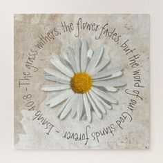 a white flower with yellow center surrounded by words on the bottom and below it is an old piece of paper