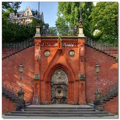 an old brick building with stairs leading up to it