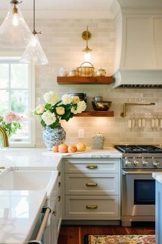 a kitchen with an oven, sink, and counter top in it's center