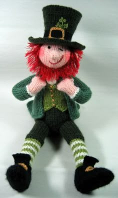 a stuffed toy is dressed in green and red