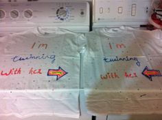 two shirts with writing on them sitting next to each other in front of washer and dryer