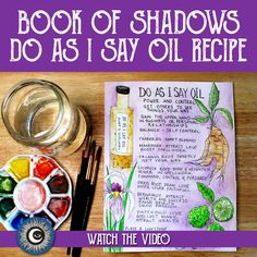 the book of shadows do as i say oil recipe is next to some paint and brushes