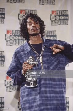 the rapper poses with his award for best rap album