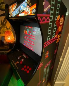 an old school arcade machine in the corner of a room with neon lights on it