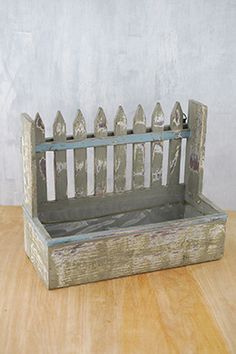 an old wooden bench sitting on top of a wooden table