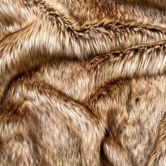 "Lynx, Warm brown base with caramel variations, with darker dyed tips, 2.5\" long pile, and the fabric width is 62\". This is the fabric I use this faux fur to make my rave review poms! This soft, luxurious, and plush faux fur fabric is available in cuts from 6\" up to 5 yards in length. This fabric is perfect for various projects, including but not limited to pompoms, pillows, blankets, stuffed animals etc. Specs: -Made From: 80% Acrylic/20% Polyester -Woven Back -Heavy Weight -Width: 62\" -No Rave Review, Dyed Tips, Animal Blanket, Faux Fur Blanket, Fur Wrap, Feature Walls, Art Exhibitions, Kids Scarf, Fur Fabric