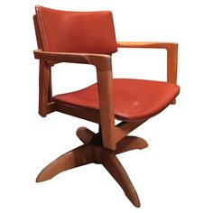 a wooden chair with red leather upholstered on the seat and armrests