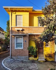 a yellow house with steps leading up to it