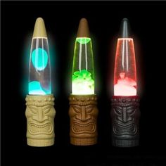 three different colored lights are in the shape of tiki heads and totems