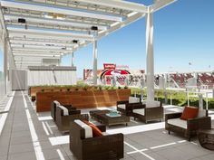 an outdoor seating area on the roof of a building with lots of chairs and tables