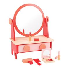 a toy vanity with mirror and makeup set