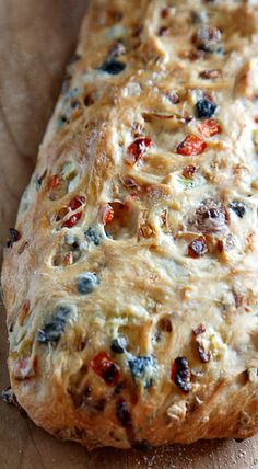 a loaf of bread sitting on top of a wooden cutting board