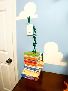 a stack of books sitting on top of a wooden table in front of a door