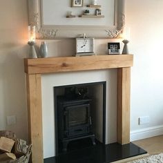 a living room with a fire place and pictures on the fireplace mantel above it