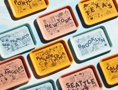 six different trays with the names of various cities and their name written on them