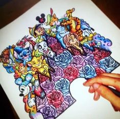 someone is drawing with colored pencils on a sheet of paper that has images of pokemon and other cartoon characters